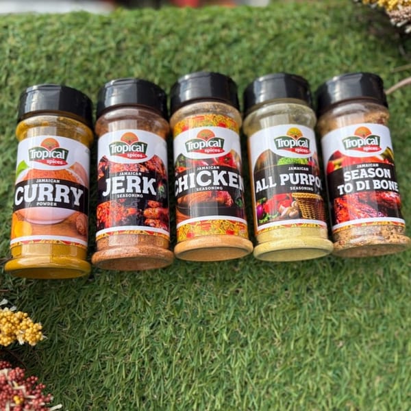 Five Tropical Spices seasoning bottles, including Curry, Jerk, Chicken, All Purpose, and Season To Di Bone.